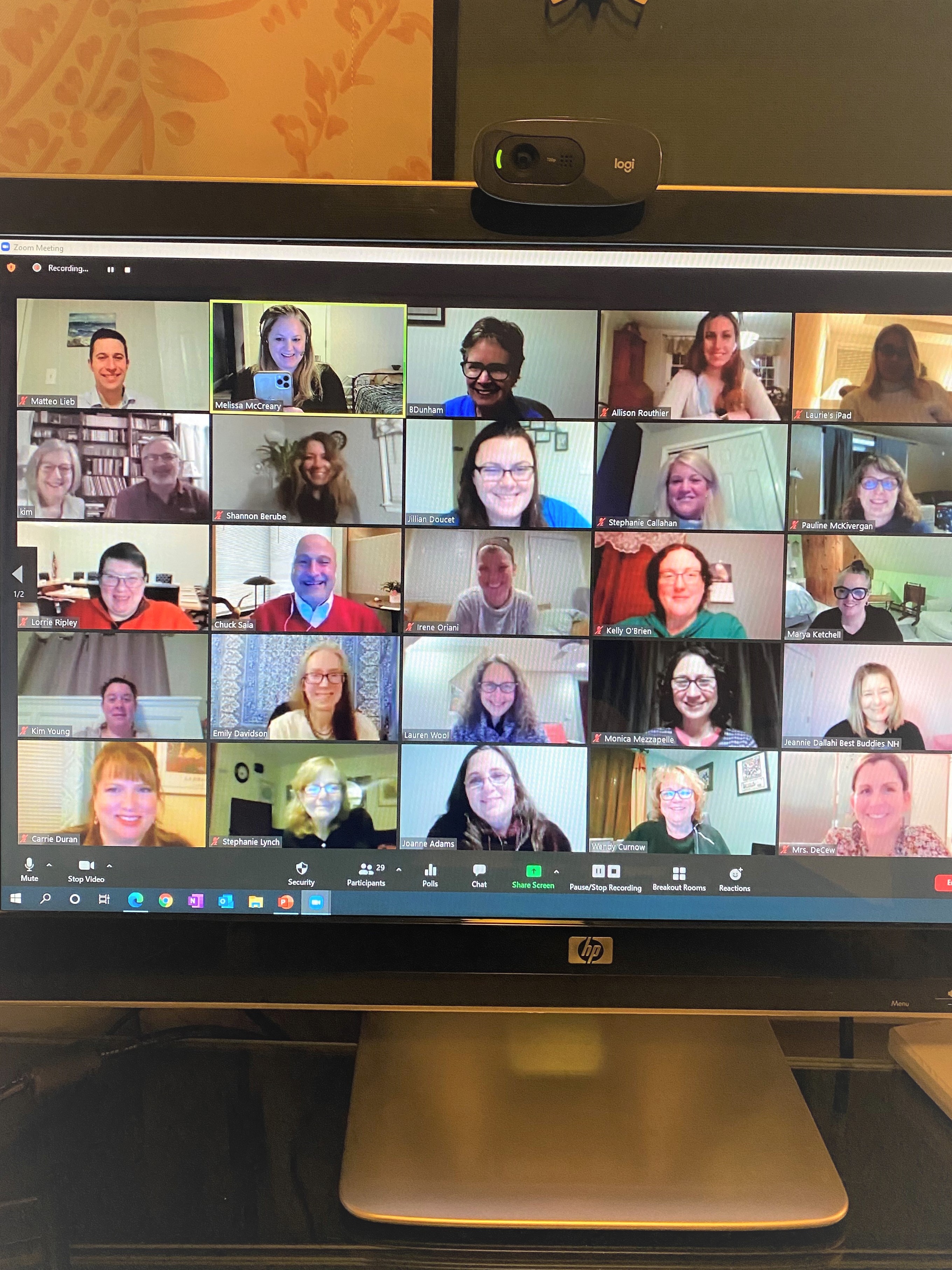 A photo of a computer monitor showing dozens of smiling participants from the Parent Info Night zoom call