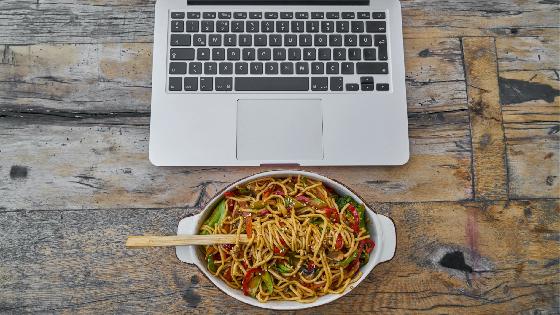 Image showing laptop and a plate of noodles