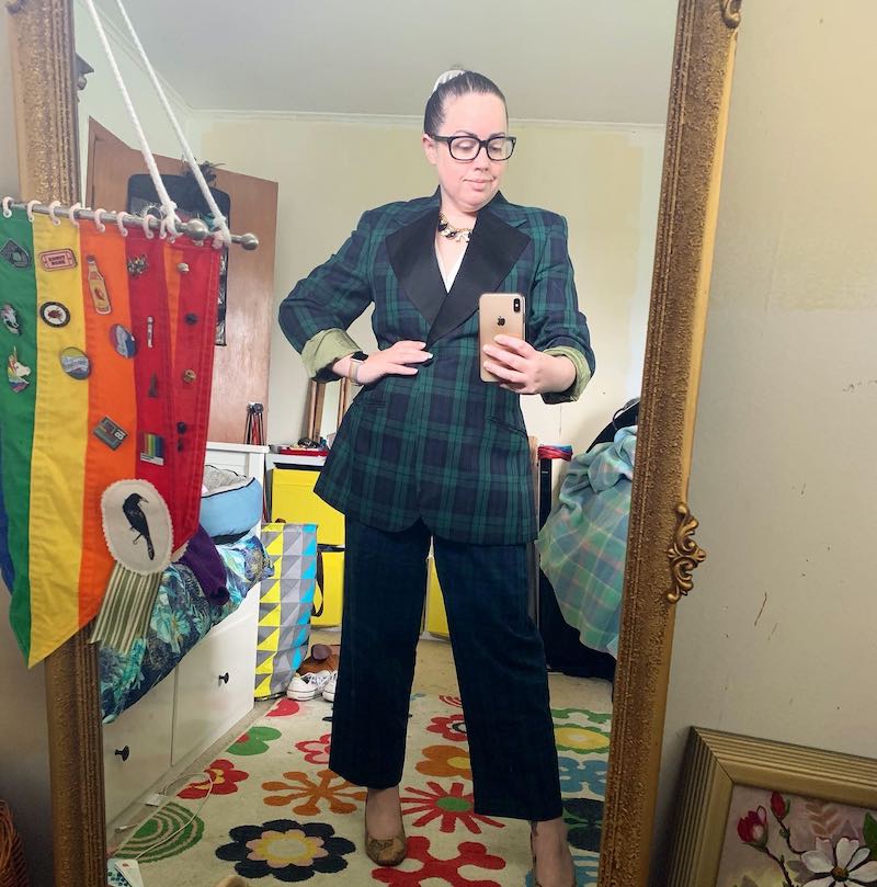 The author poses for a selfie wearing op shop purchased clothes