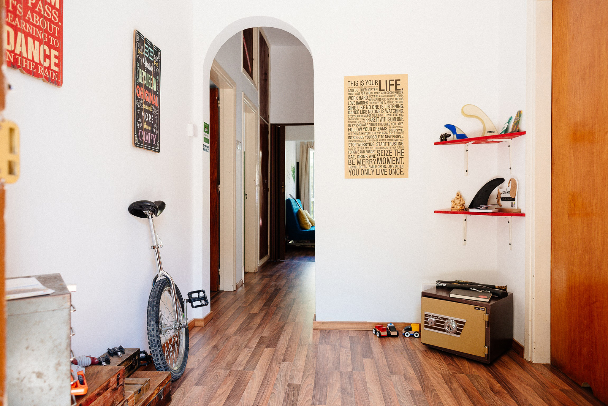 Photo of a hallway with a unicycle resting against the wall