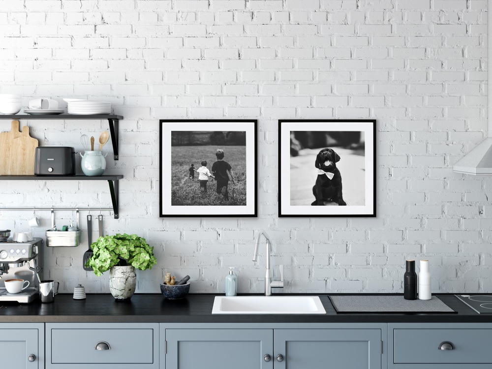 Framed prints of family against backsplash in kitchen