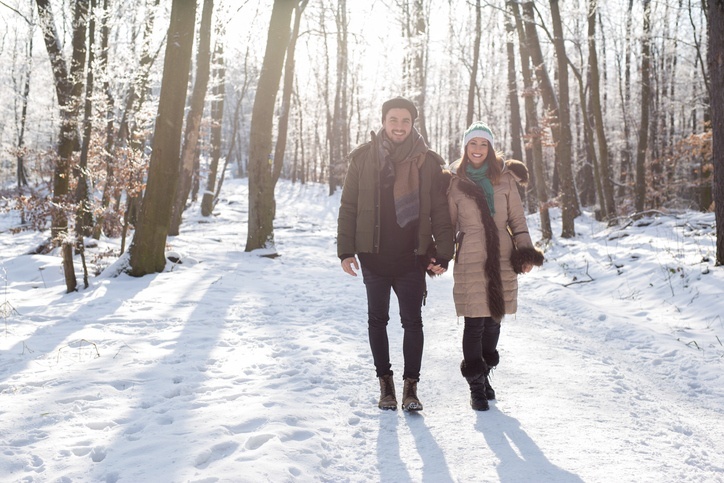 Couple walking in the woods during the holidays