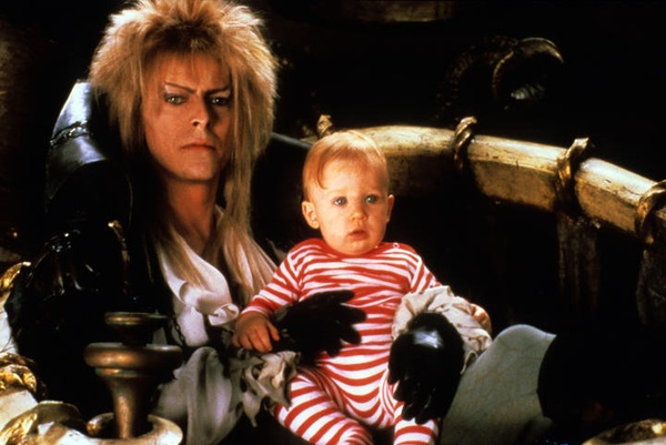 Photo of the Goblin King (David Bowie) holding baby Toby in his lap