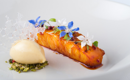 Stunning dessert dish with sous vide pineapple, tropical sorbet, crushed pistachios and topped with colourful edible flowers. Photo credit: https://www.greatbritishchefs.com/recipes/caramel-pineapple-pink-peppercorns-recipe