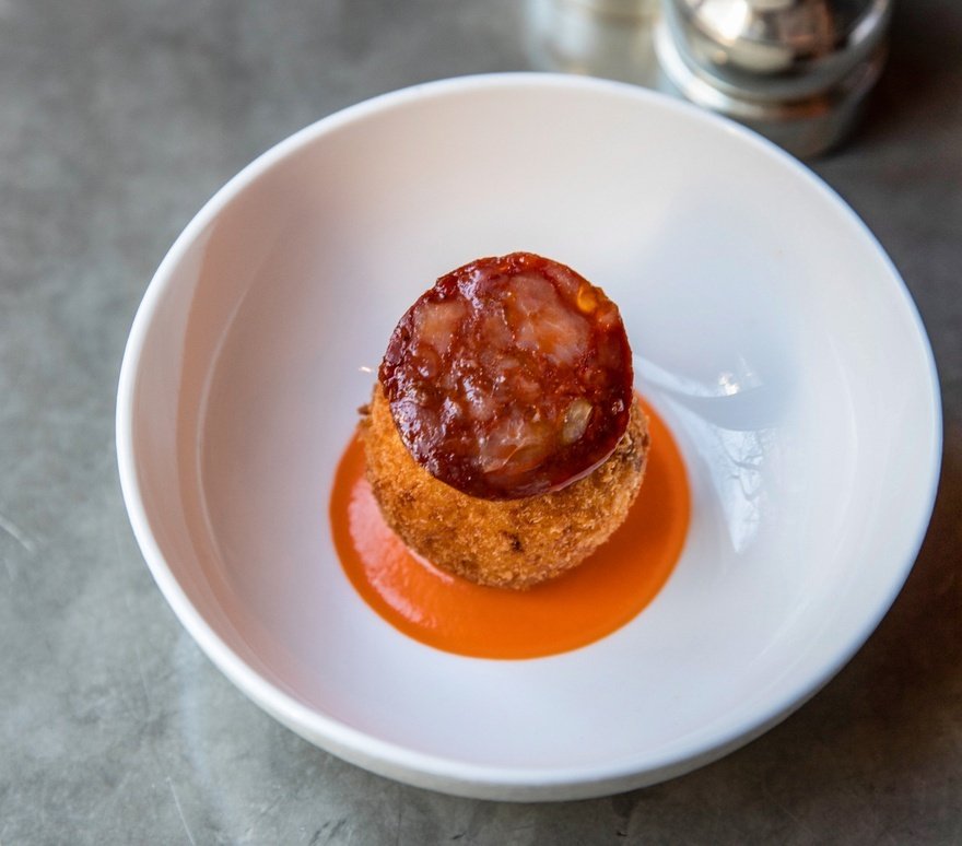 Salt cod scotch egg with chorizo and red pepper sauce