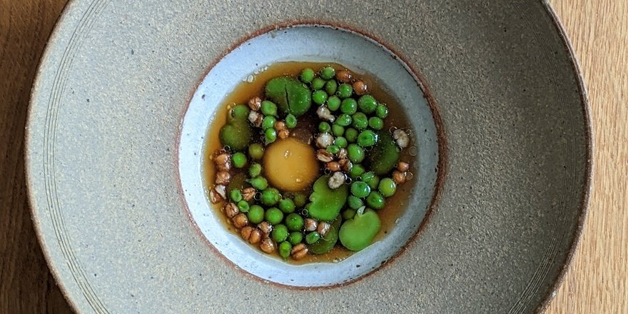Quail egg with broad beans, peas and pink fir apple potato broth